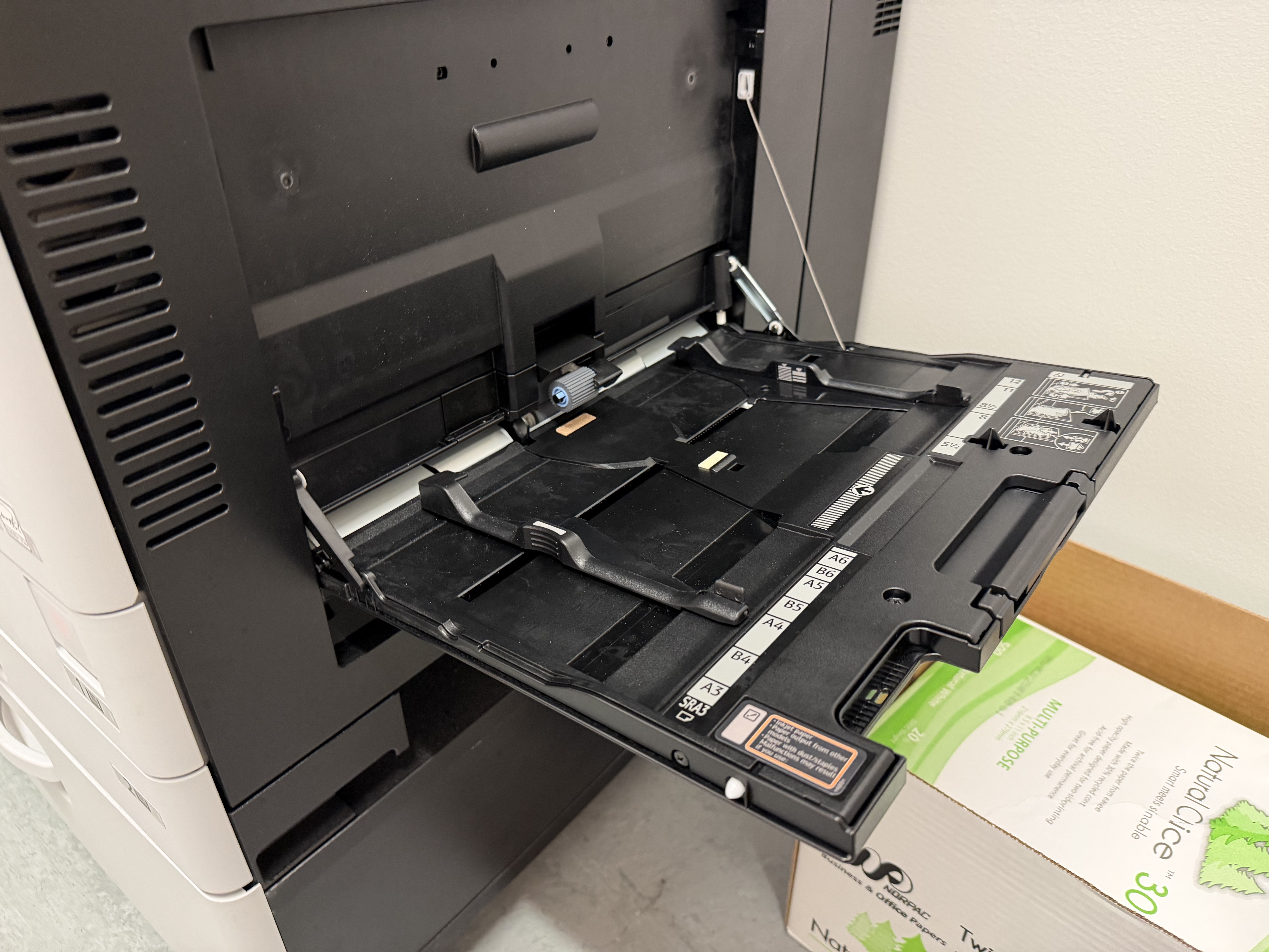 An open bypass tray on a printer