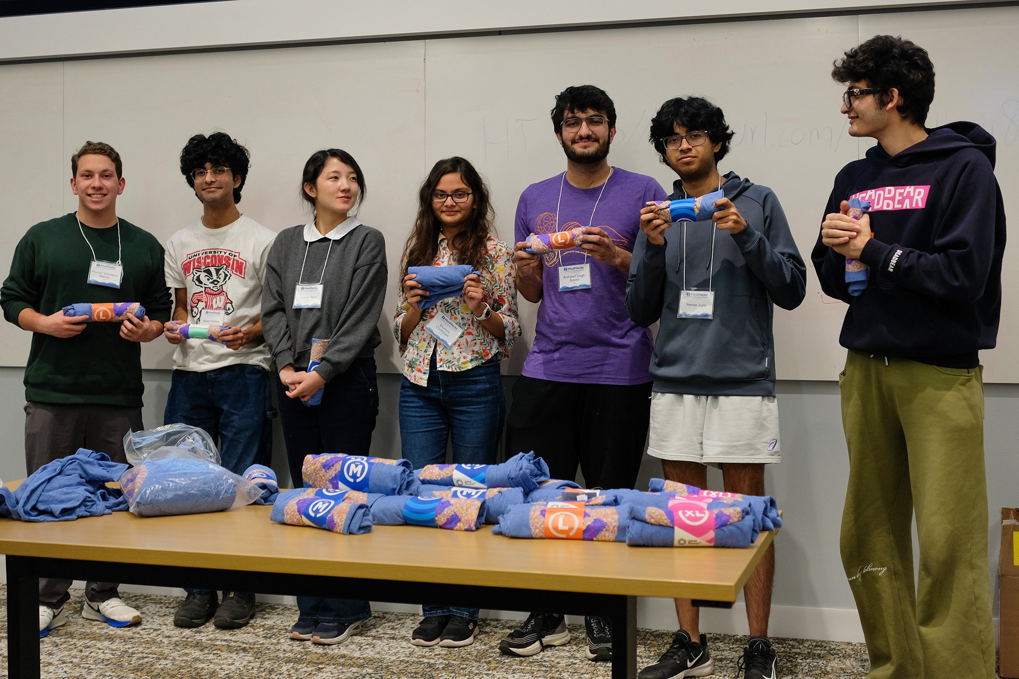 Estimathon participants pose with T-Shirts