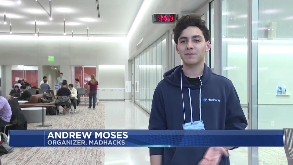 Screenshot from WMTV of Andrew being interviewed at MadHacks