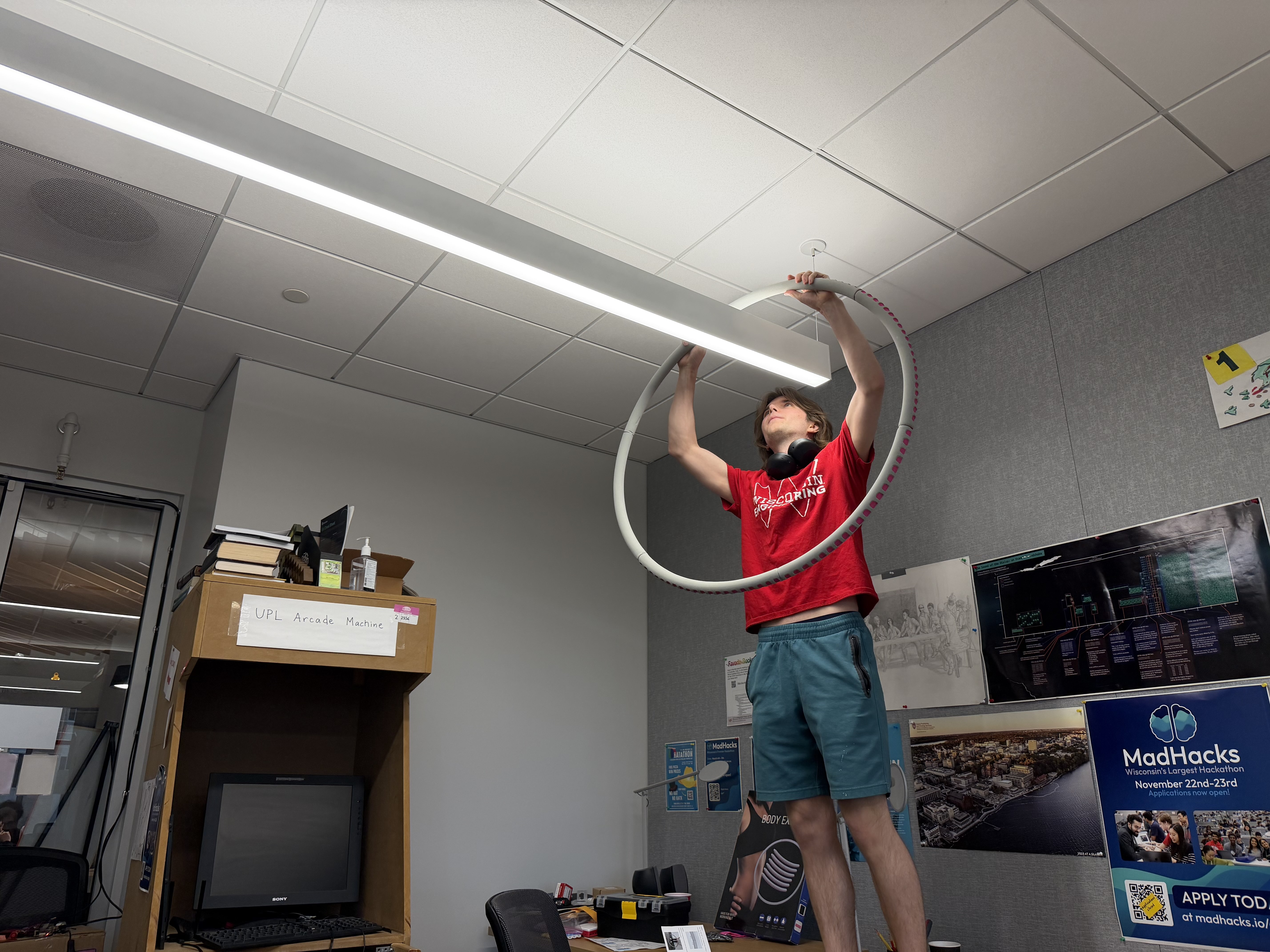 Noah putting a hula-hoop on a light