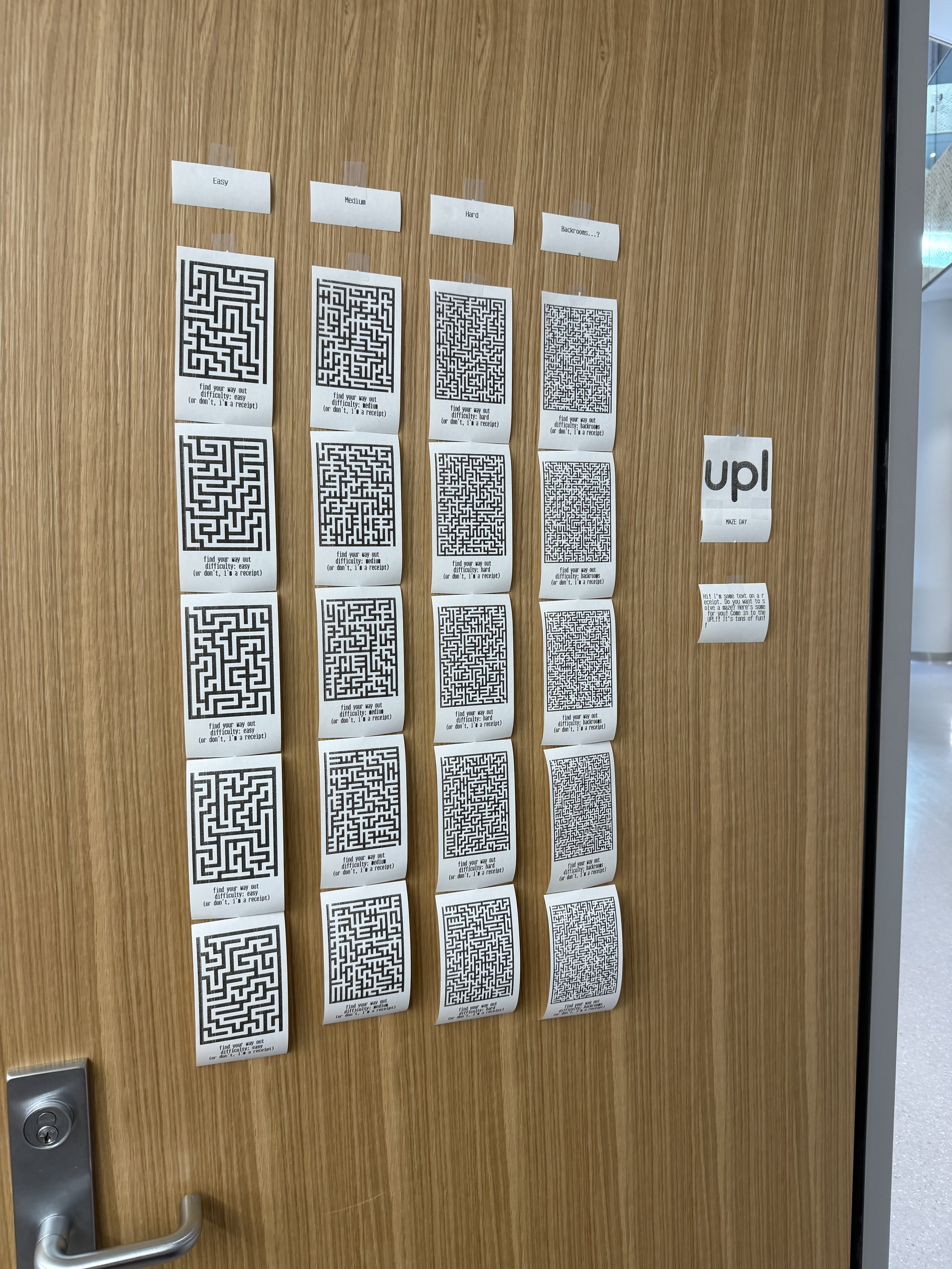 Receipt papers with mazes on them, placed on a door